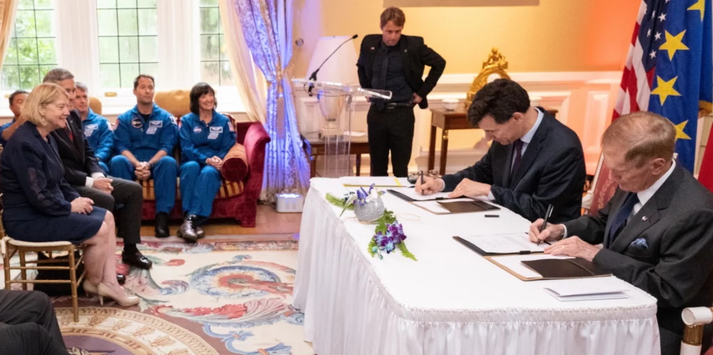 French and U.S. officials signed the Artemis Accords during an official ceremony attended by astronauts and featuring international flags